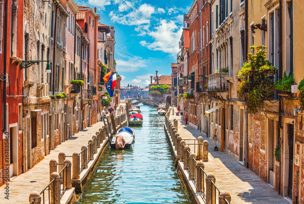 Street in Venice with canal boat and blue sky white cloud