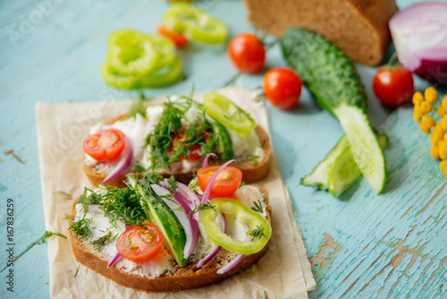 Sandwich with herb pesto and edible nasturtium flowers