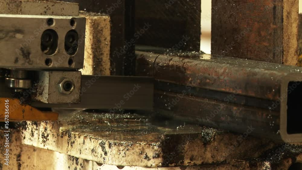 Close up, machine cuts through steel beam Close up, machine cuts through steel beam