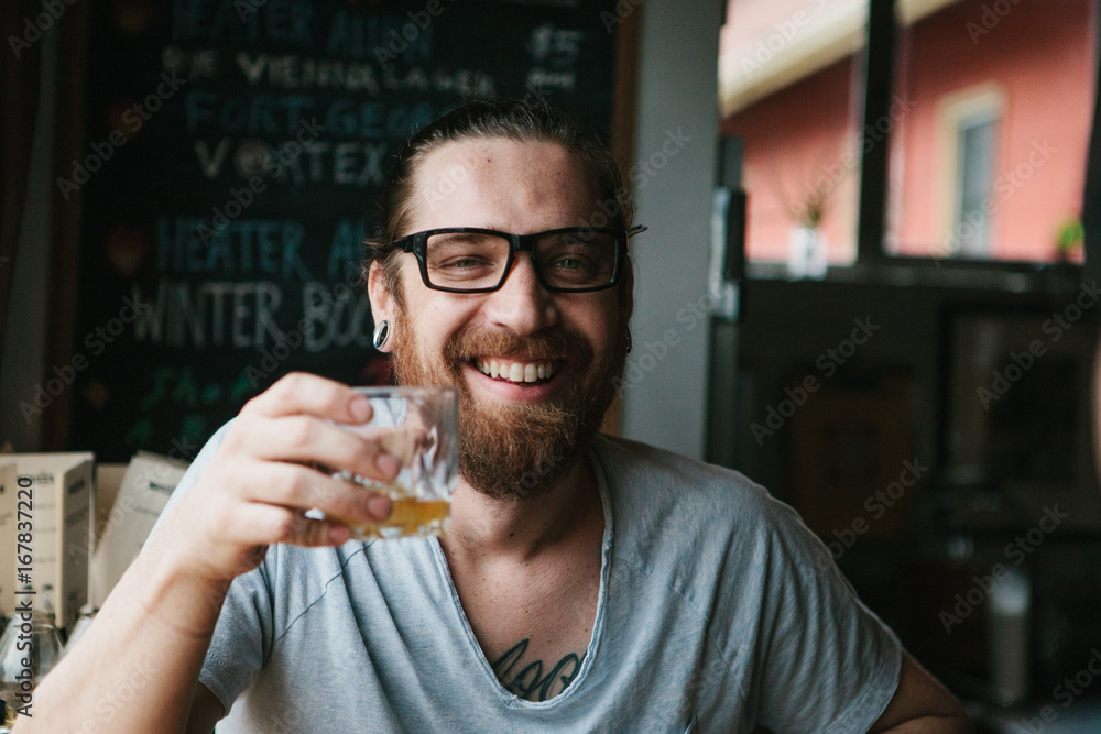 Two guy friends smiling and talking at a bar Two guy friends smiling and talking at a bar