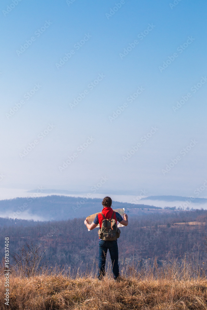 Man Looking At Map While On An Overlook Man Looking At Map While On An Overlook