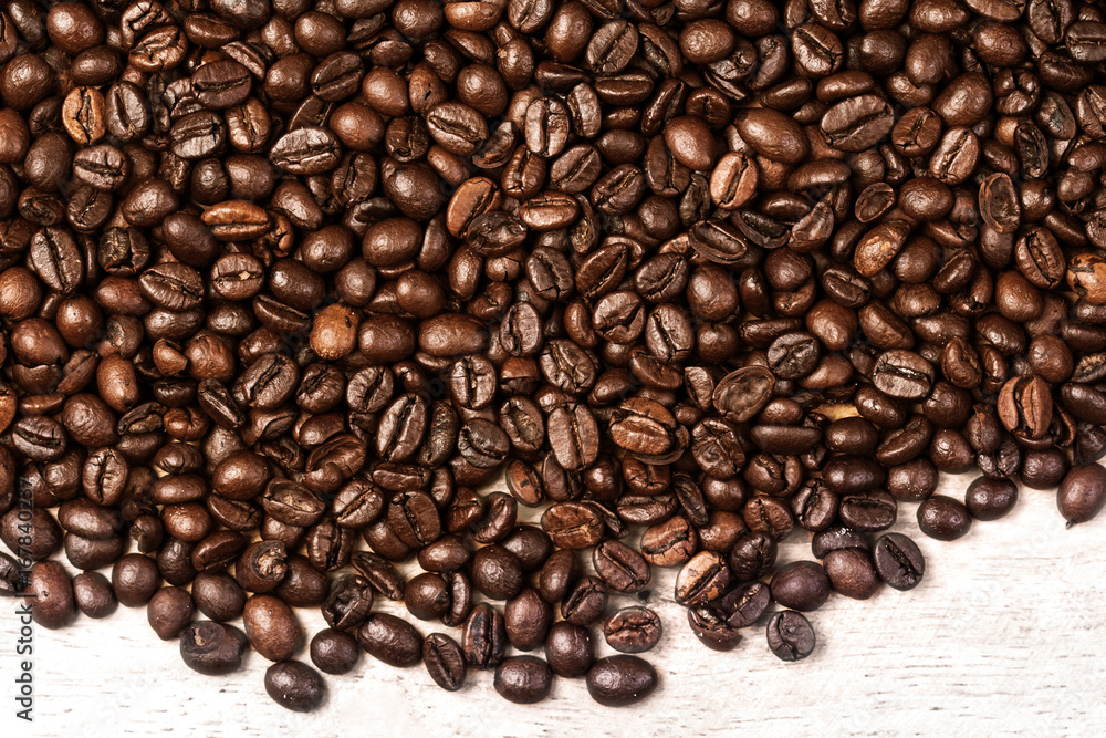 Fototapeta premium Fresh Coffee beans background macro. Dark Roasted coffee beans textured wallpaper for your design with copy space.