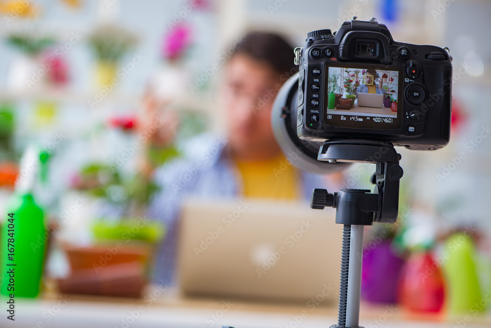 Man florist gardener vlogger blogger shooting video on camera Man florist gardener vlogger blogger shooting video on camera