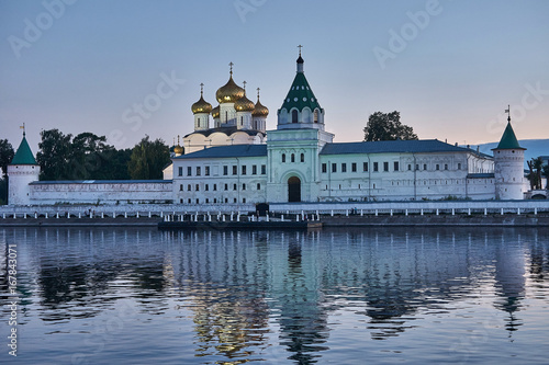 Monastery in the rays of sunset/Ipatievsky Monastery in Kostroma. The domes are illuminated with searchlights.The monastery is on the river bank and is reflected in the river.Golden Ring of Russia