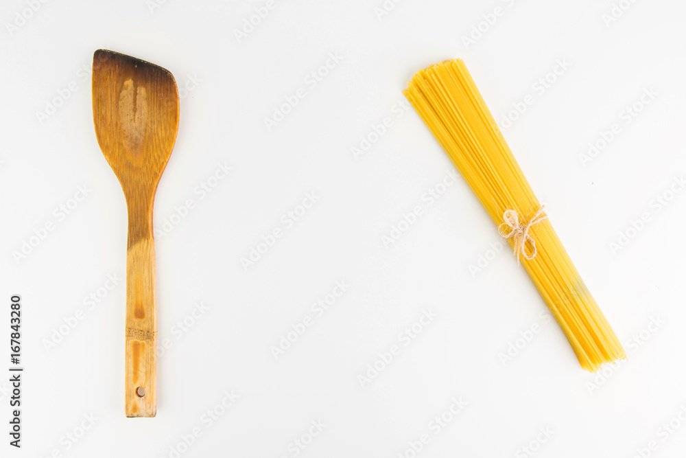 Kitchen Utensil  With Raw Italian Spaghetti Pasta On White Background Closeup