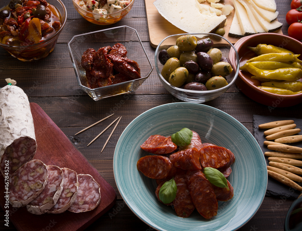 Tapas starters on wooden table Tapas starters on wooden table