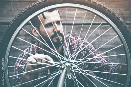 man repairing bike