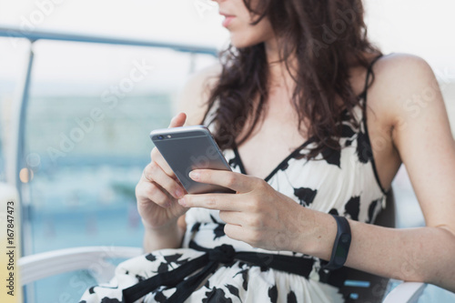 Woman in beautiful dress is holding  smartphone