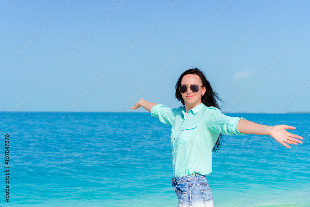 Young beautiful woman on tropical seashore background the sea Young beautiful woman on tropical seashore background the sea