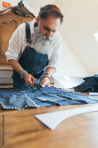 Indoor Portrait of Fashionable Senior Tailor Working on Boro Patchwork