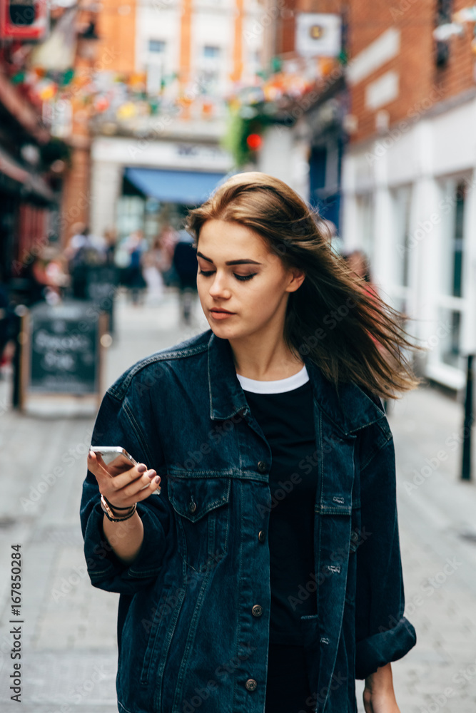 Brunette woman in the city with a cell phone Brunette woman in the city with a cell phone