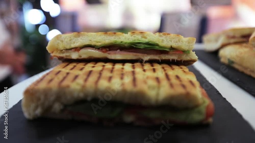 Chef places paninis on counter, close up