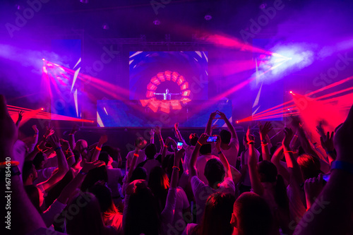 Disco club with dj on the stage.