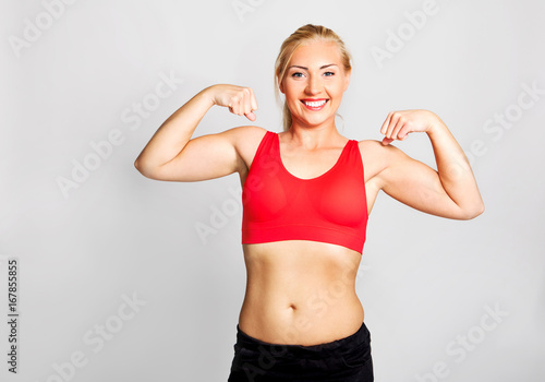 Young woman showing biceps