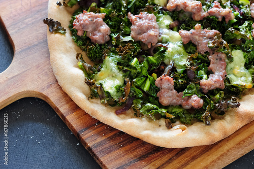 pizza with sausages and kale