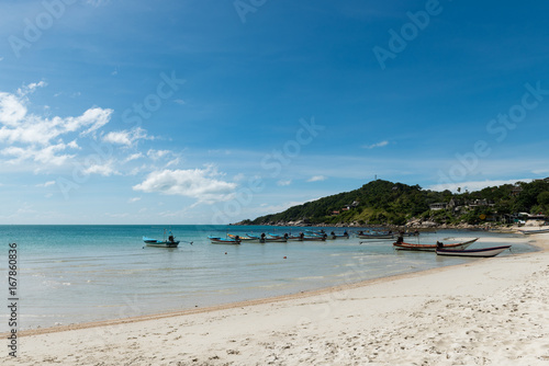 Floating boats in the clear blue sea and beautiful summer sky at Haad Rin  Koh Phangan  Thailand