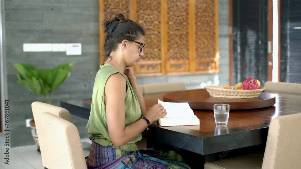 Woman looks bored while turning pages in the book, steadycam shot
Woman looks bored while turning pages in the book, steadycam shot