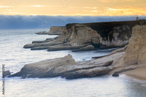 Foggy Sunset Coastline. Panther Beach, Davenport, Santa Cruz County, California, USA. photo