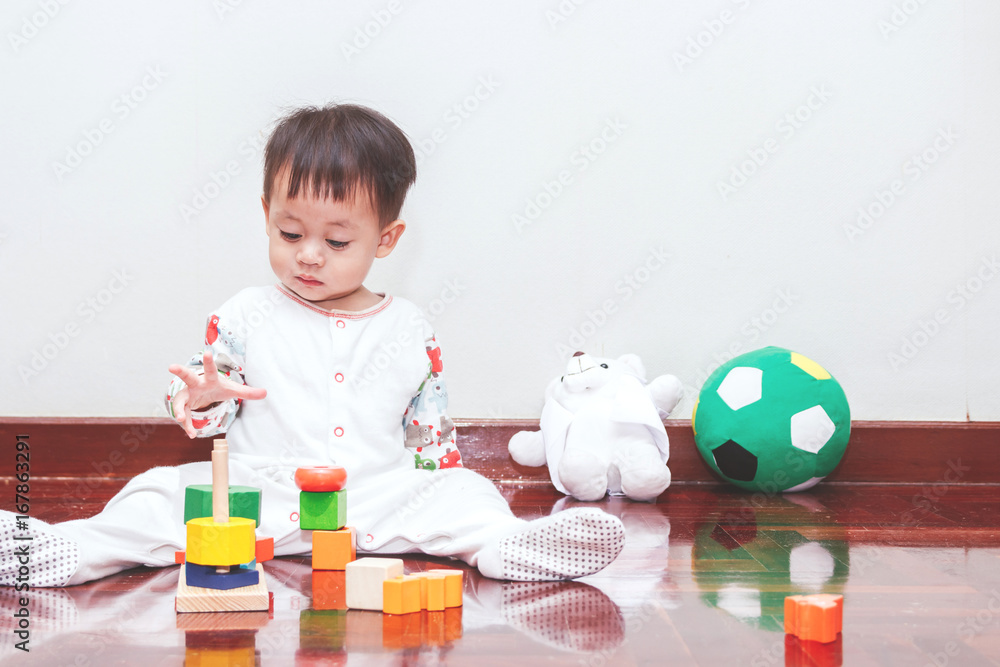Baby boy playing with wooden blocks Baby boy playing with wooden blocks