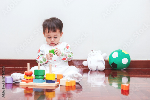 Baby boy playing with wooden blocks