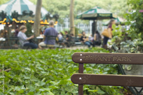 Bryant park background wallpaper high res bench with people leusure concept relaxing in the city natural resources and casual atmosphere upscale new york. photo