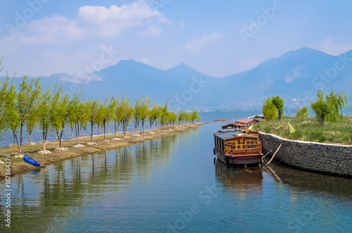 Lijiang Lashi Lake Wetlands is a national natural scenic spot near the city of Lijiang,China. The tourist activities there include horse riding, bird watching, boat ride and fishing.  photo