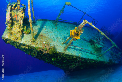 A shot of the sunken shipwreck of the captain keith tibbetts on little cayman. This old russian destroyer has been sunk to make an artificial reef for marine life in the ocean and for scuba divers  photo