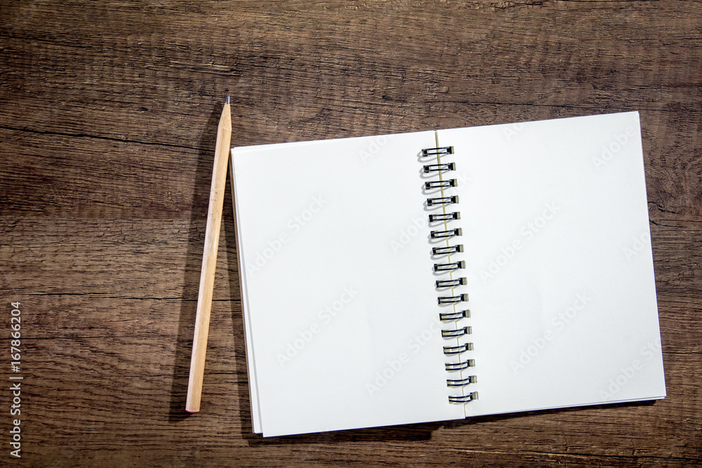 Top view Notebook paper on wooden background. Concept for business and education.