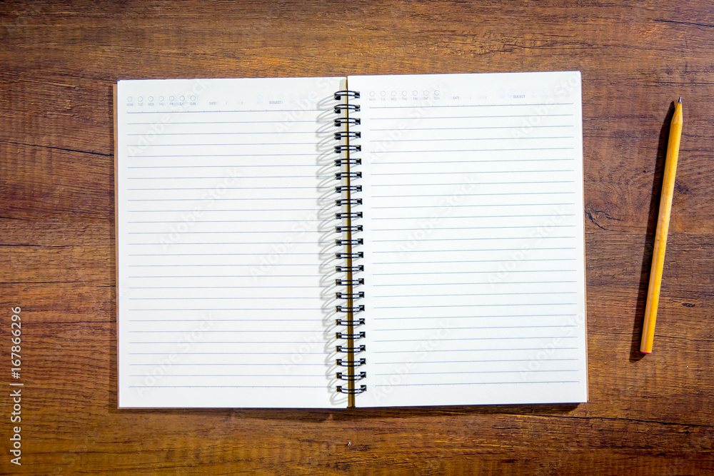 Top view notebook paper on wooden background. Concept for business and education. Top view notebook paper on wooden background. Concept for business and education.
