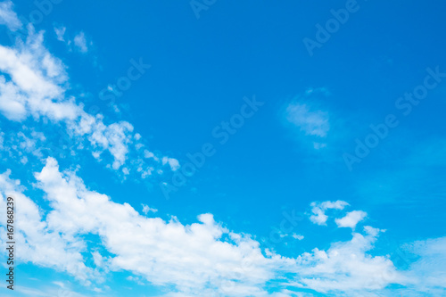 Beautiful blue sky with a fluffy clouds in summer.