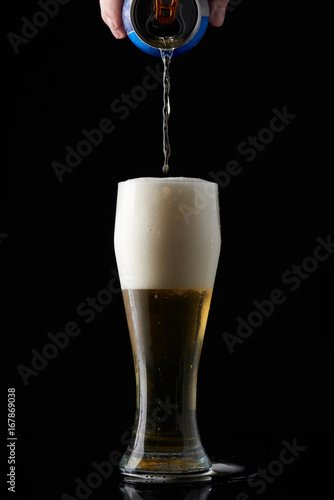 Pouring beer from metal can 