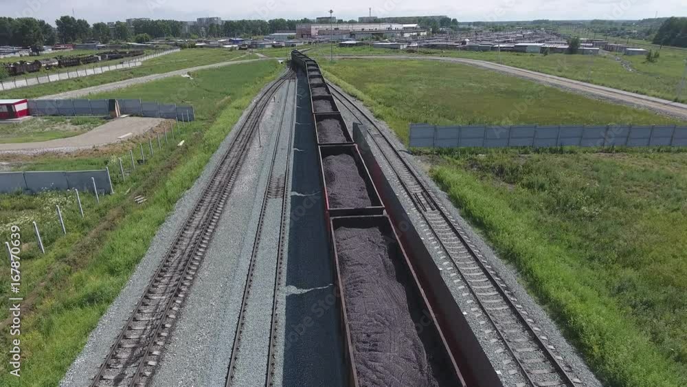 Aerial view UHD 4K of freight train with wagons and standing train with coal Aerial view UHD 4K of freight train with wagons and standing train with coal