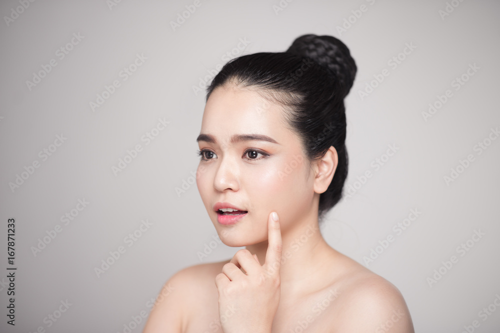 Happy smiling beautiful asian woman touching her face. Happy smiling beautiful asian woman touching her face.