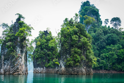 Magical landscape with limestone pillar over water