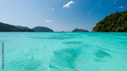 Fototapeta Naklejka Na Ścianę i Meble -  Blue and bright sea water surface at the open sea, Beautiful blue sea at Surin island, Thailand
