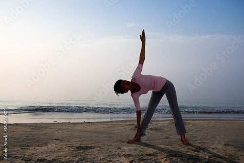 Yoga girl on the beach