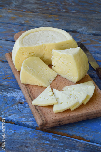 Photography young homemade cheese on a blue wooden background