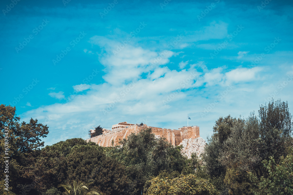 Old Greek ruins in background with wide blue sky