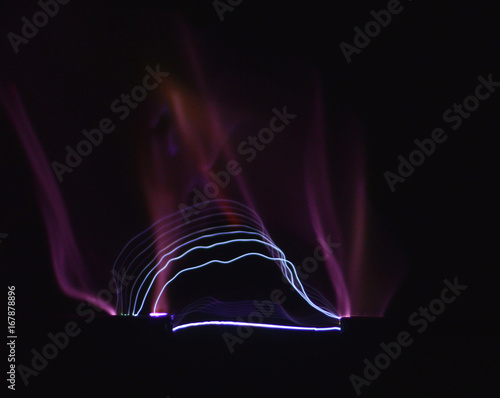 Electric arc between two electrodes seen on a black background. photo