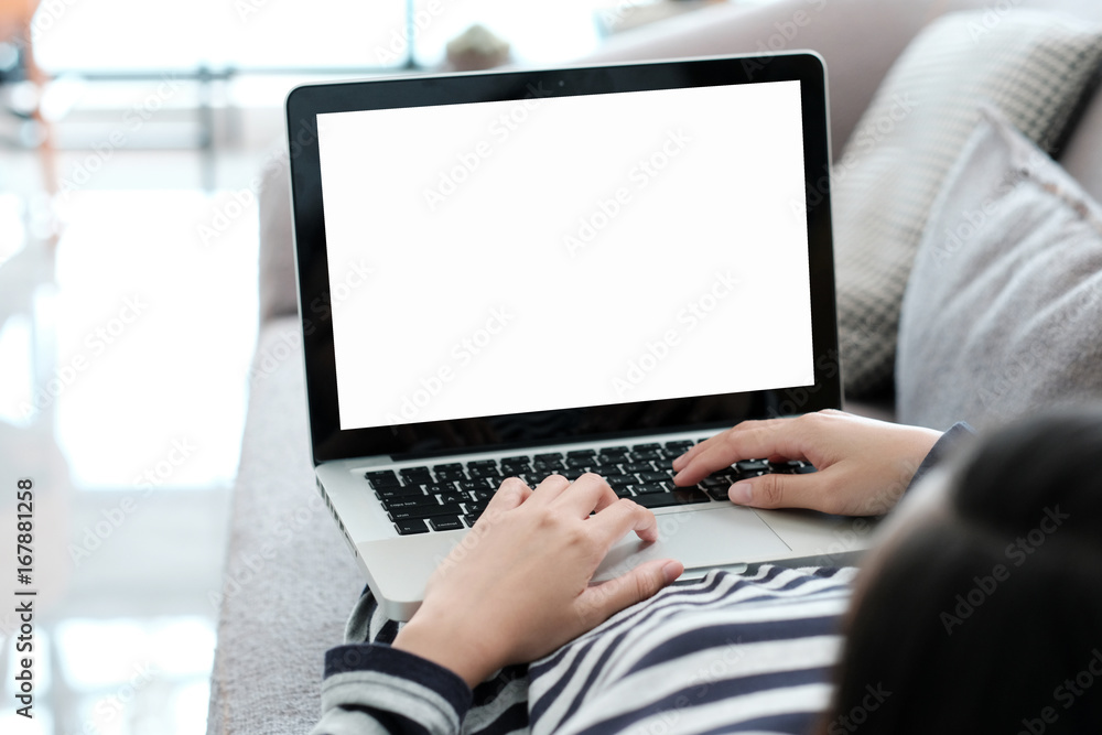 Woman hand typing labtop computer with blank screen for mock up, technology and lifestyle concept Woman hand typing labtop computer with blank screen for mock up, technology and lifestyle concept