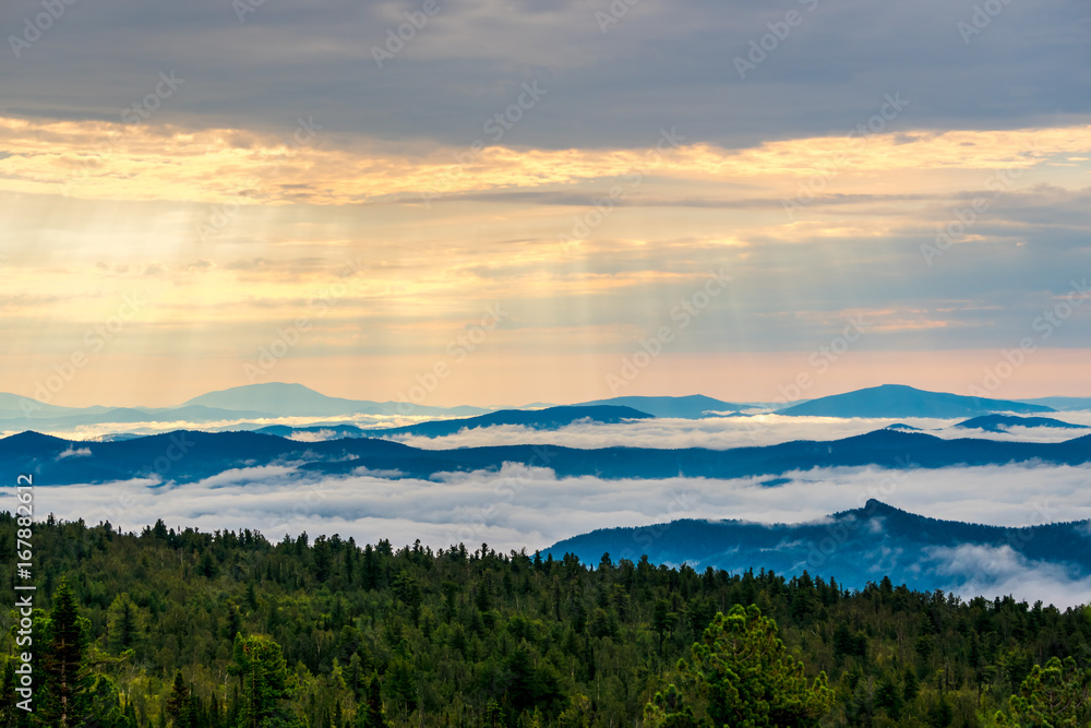 Breathtaking sunrise and mist over the tops of mountains and woods
Breathtaking sunrise and mist over the tops of mountains and woods
