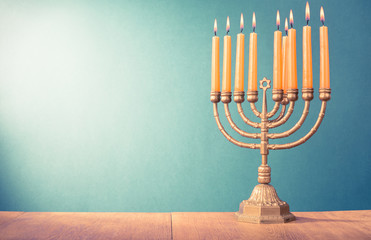 Hanukkah menorah with burning candles for holiday card background. Retro old style filtered photo