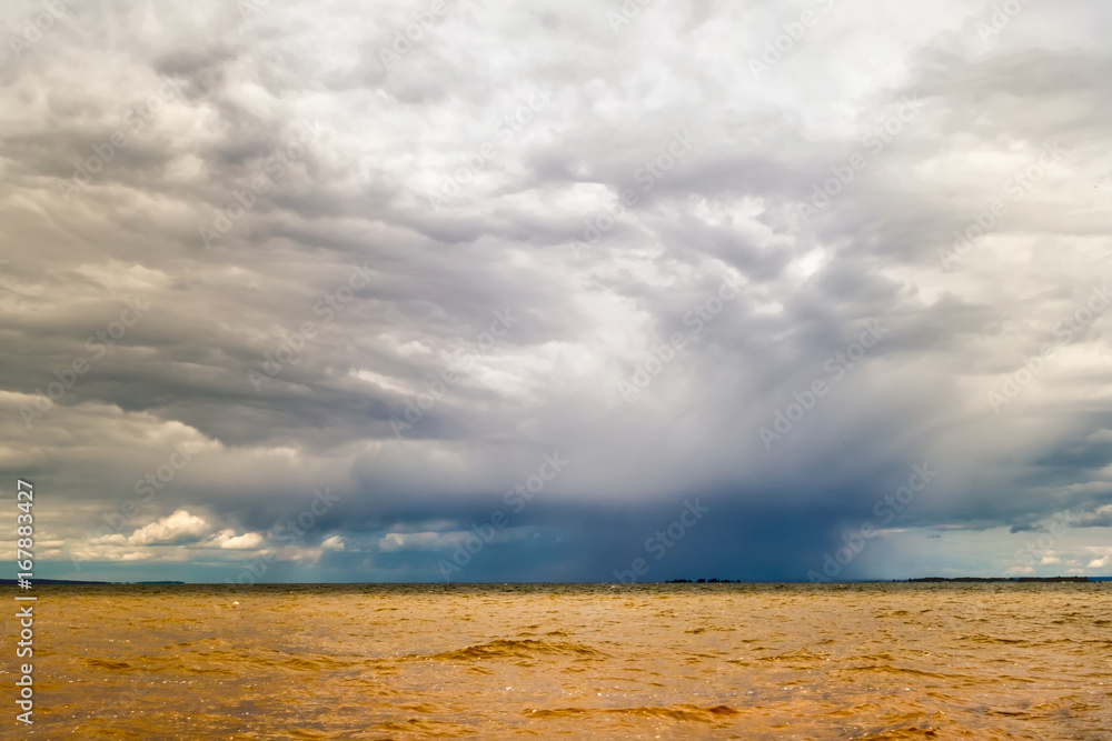Thundercloud over the yellow river.
Horizontal frame. A dark blue cloud sheds rain in the yellow turbulent water Thundercloud over the yellow river.
Horizontal frame. A dark blue cloud sheds rain in the yellow turbulent water