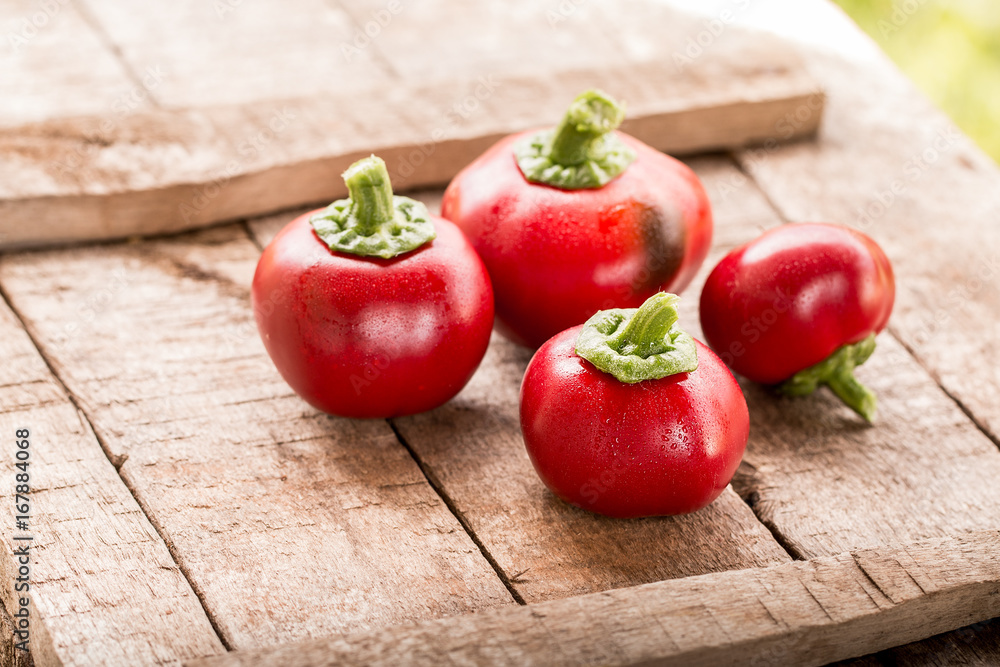 Fresh sweet red pepper on old wooden background. Fresh sweet red pepper on old wooden background.