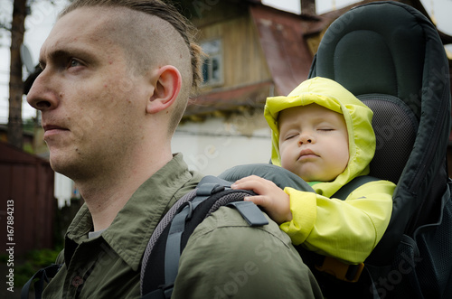 Obraz na płótnie Travelling with a child. One year old child travelling in touristic baby carrier. w salonie