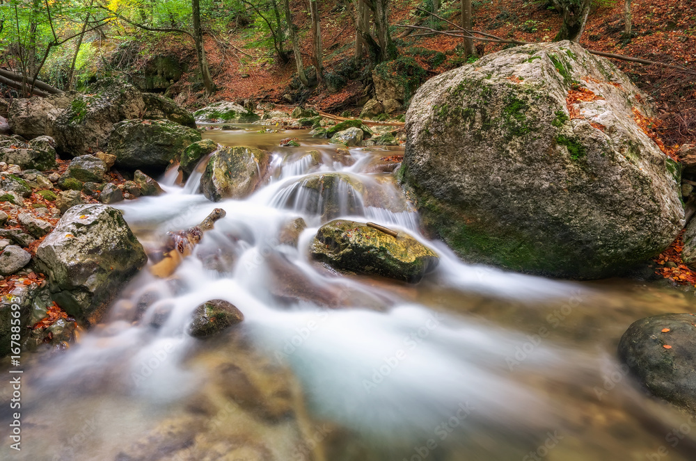 Autumn creek woods with yellow trees foliage and rocks in forest mountain. Autumn creek woods with yellow trees foliage and rocks in forest mountain.