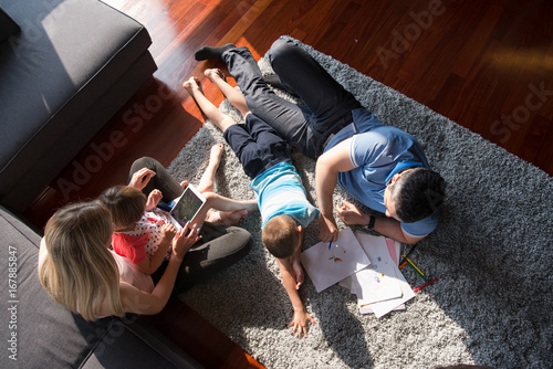 young couple spending time with kids top view