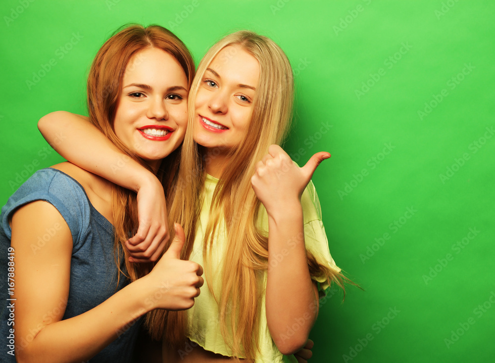 Positive friends portrait of two happy girls - funny faces, emo Stock Photo  | Adobe Stock