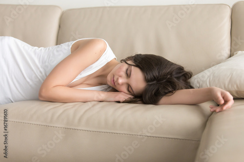 Photos Young woman lying asleep on couch, sleeping attractive girl taking nap at home,