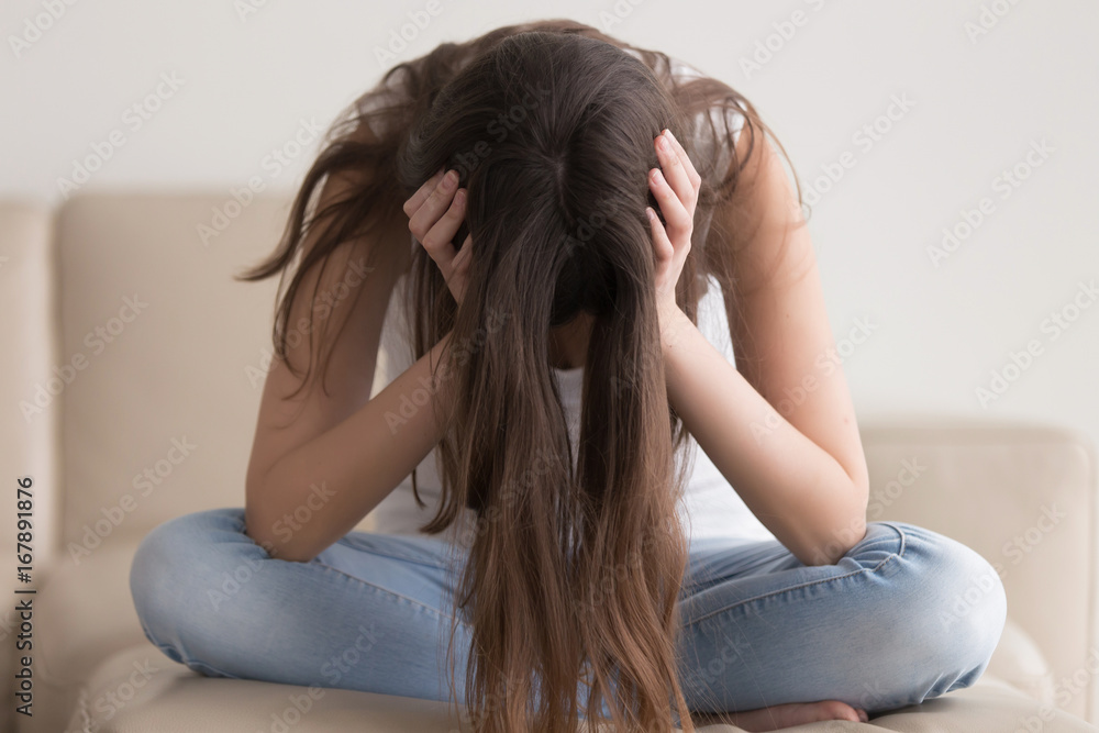 Depressed teenager sitting holding head in hands, stressed sad young woman having mental problems, feeling bad, need psychological help, addicted heartbroken girl experiencing adolescence crisis Depressed teenager sitting holding head in hands, stressed sad young woman having mental problems, feeling bad, need psychological help, addicted heartbroken girl experiencing adolescence crisis